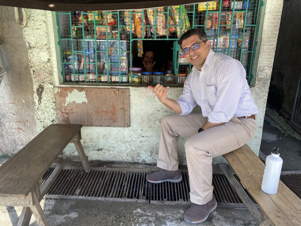 Shubhrendu, Co-Founder & CEO, visiting a yufin user behind the counter of her sari-sari store