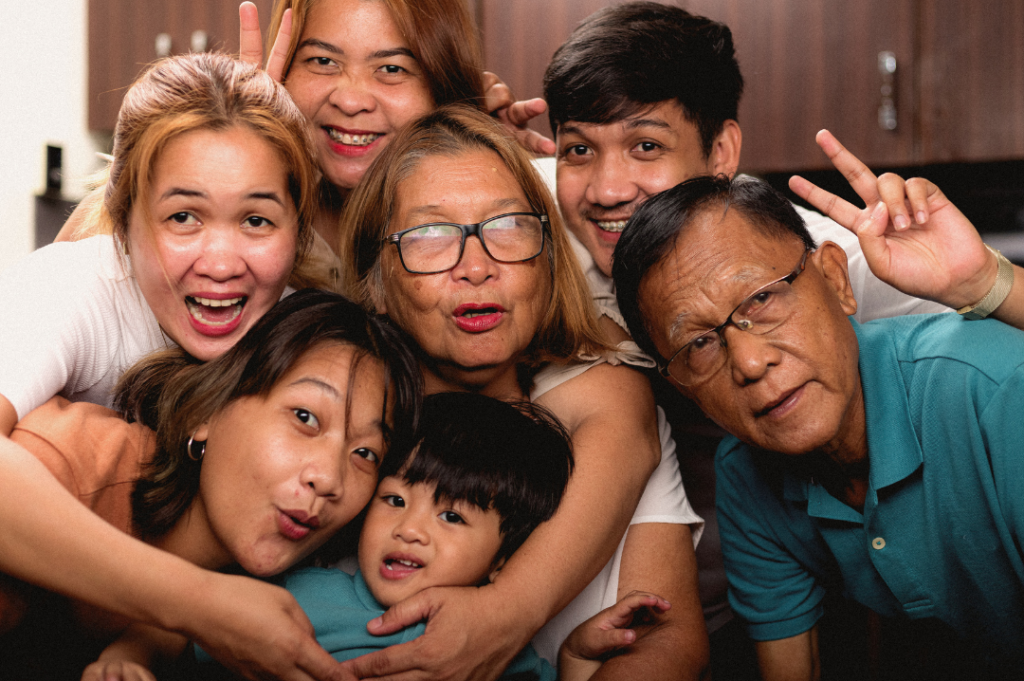 A Filipino family smiling at the camera.