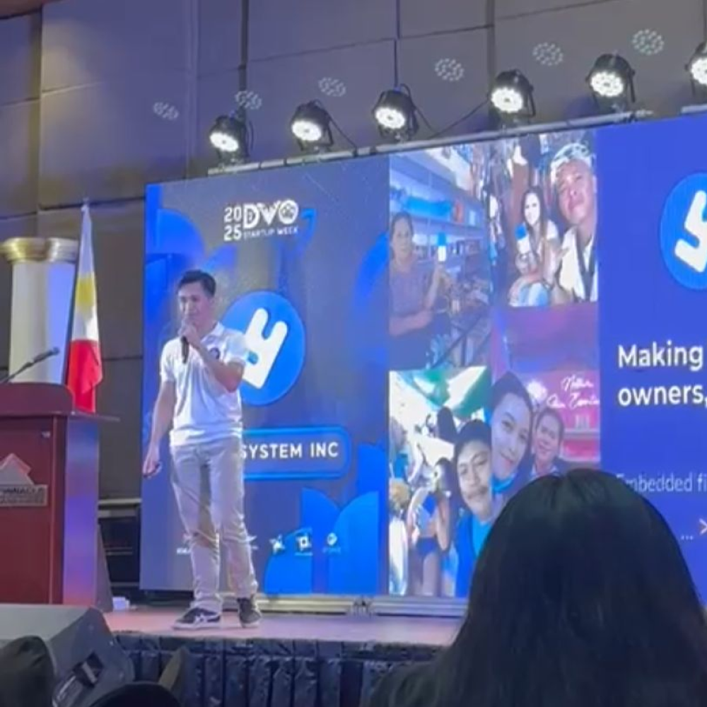 A yufin employee presenting on stage at the event.