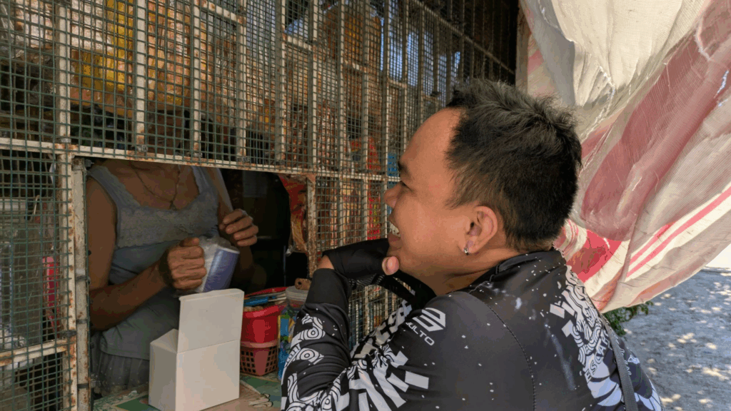 A yufin employee in front of a sari-sari store.